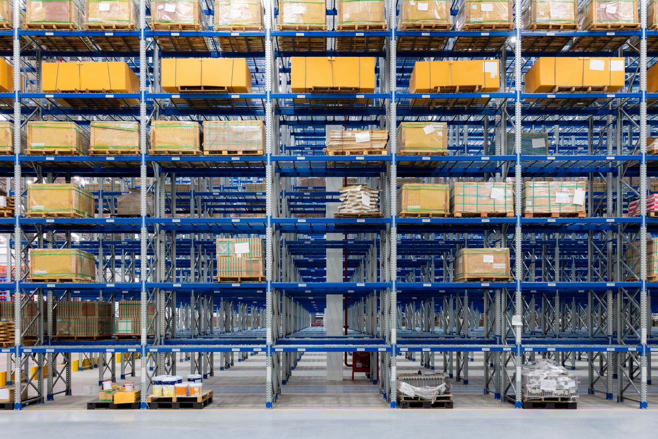 Blue shlving in a warehouse loaded down with boxes