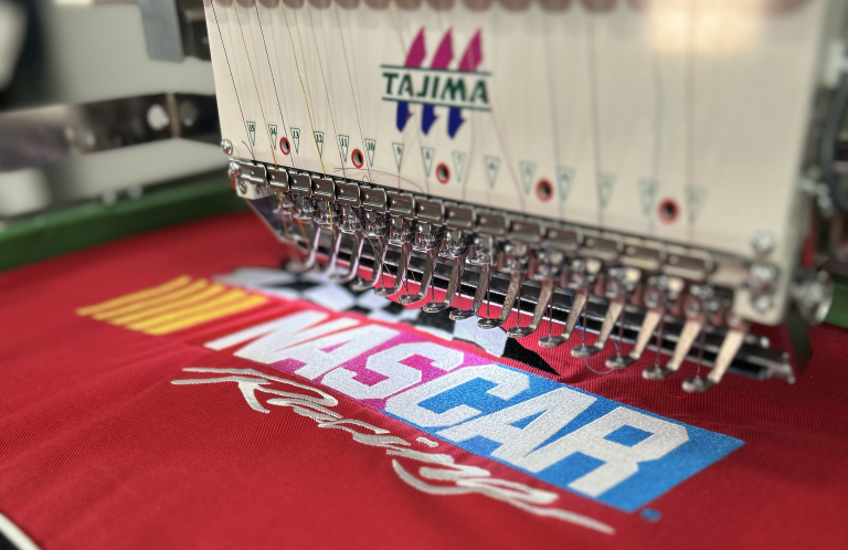 Embroidery machine stitching a NASCAR design