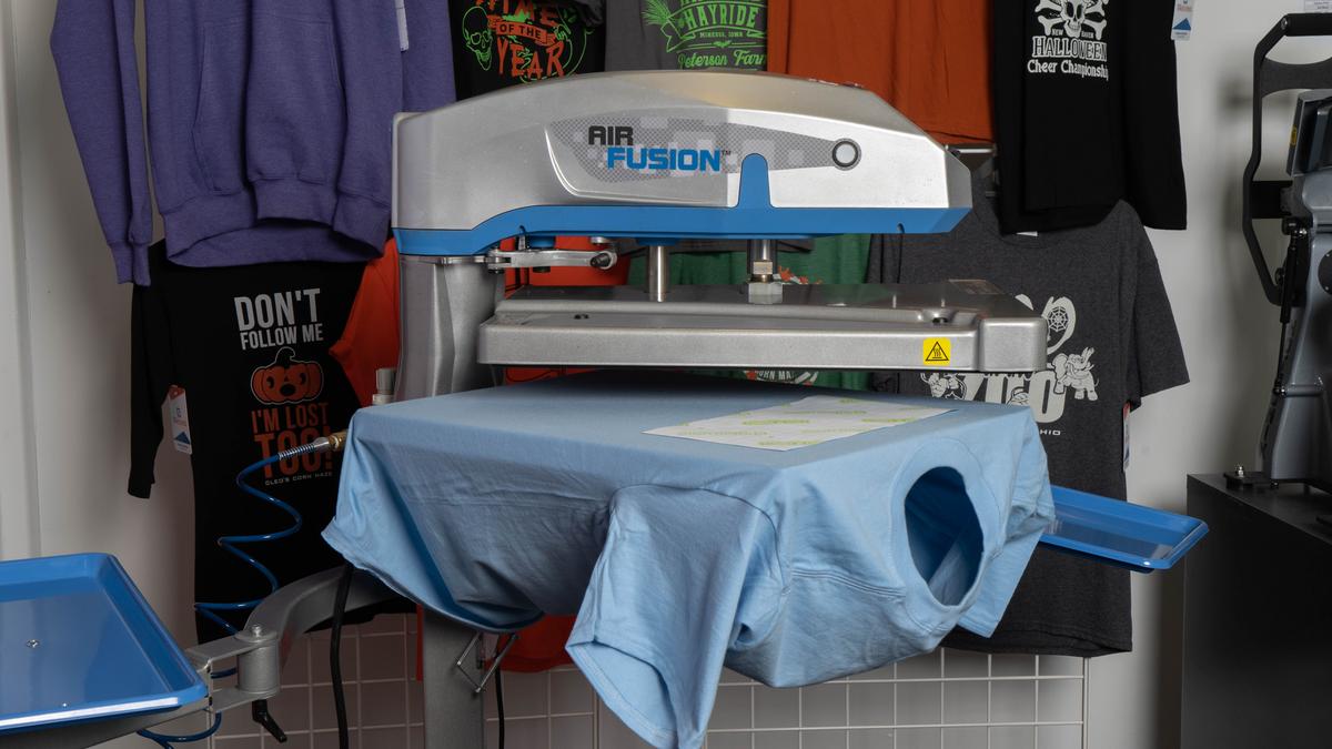 The STAHLS' hotronix heat press surrounded by apparel