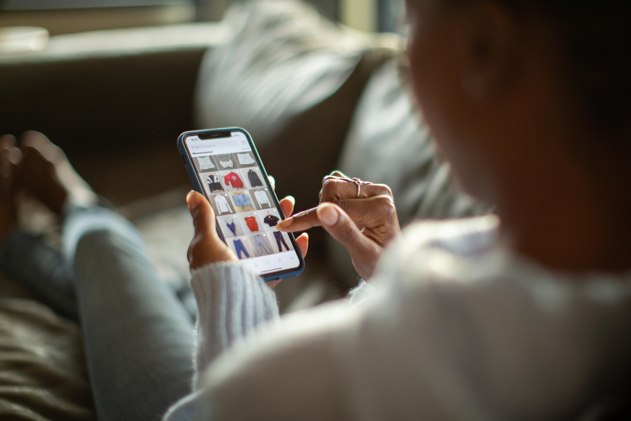 A woman purchasing clothing on her mobile device