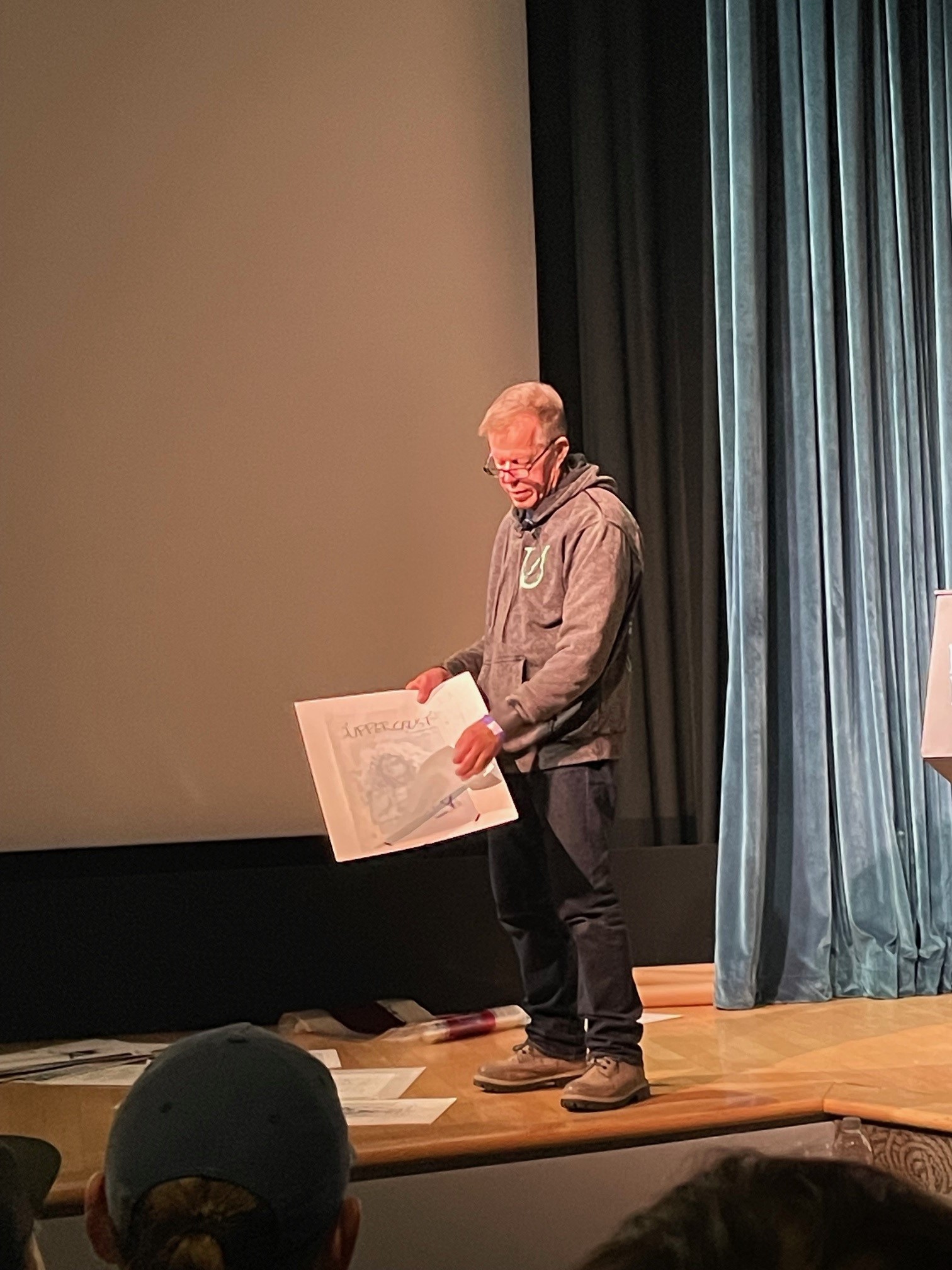 Derek Hess holding a poster