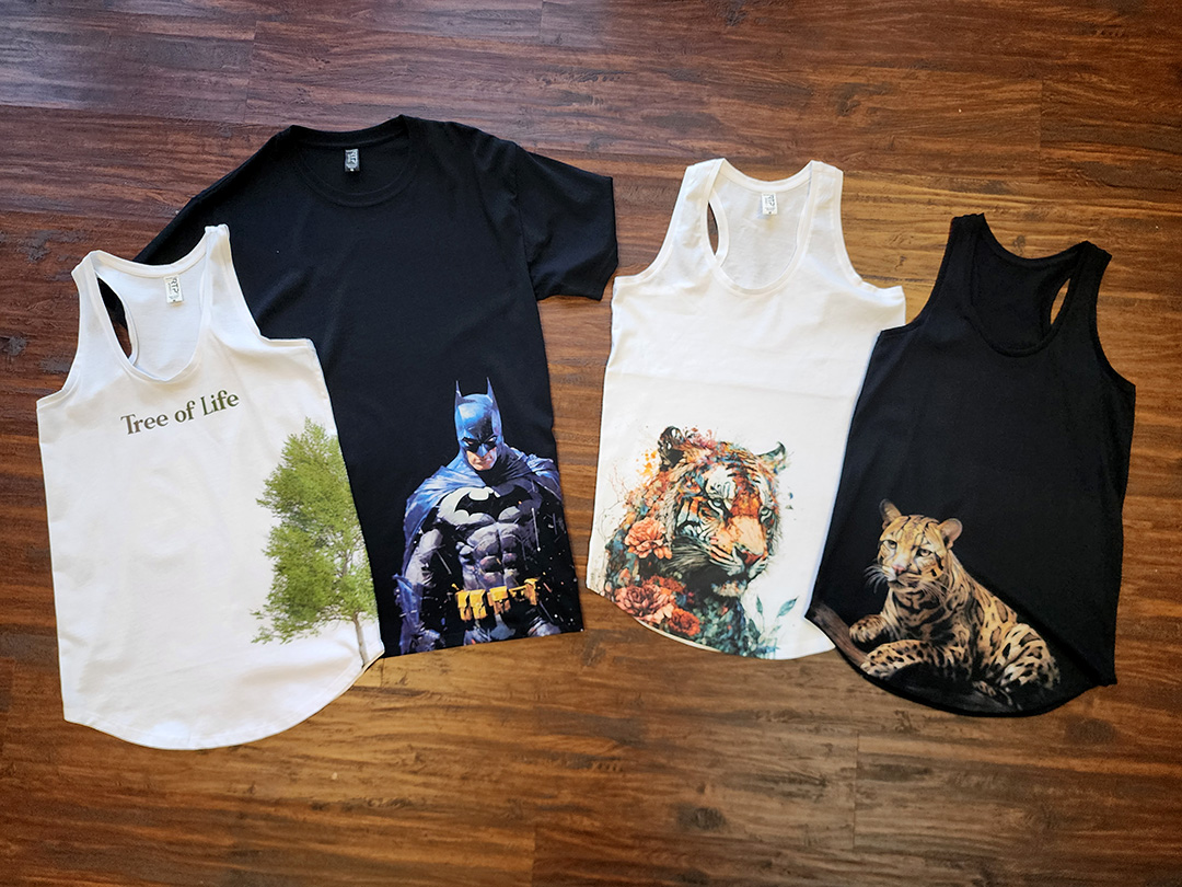 four blank garments lined up with various image placements