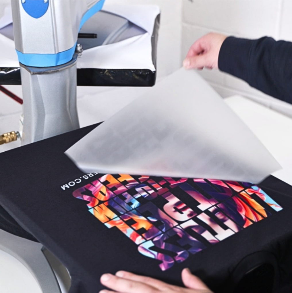 Peeling the DTF transfer off of a black T-shirt