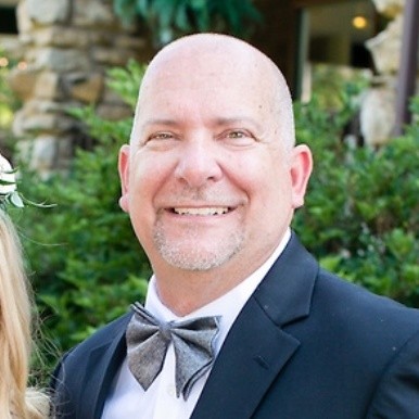 Kendall Whitley male headshot smiling at camera in tuxedo