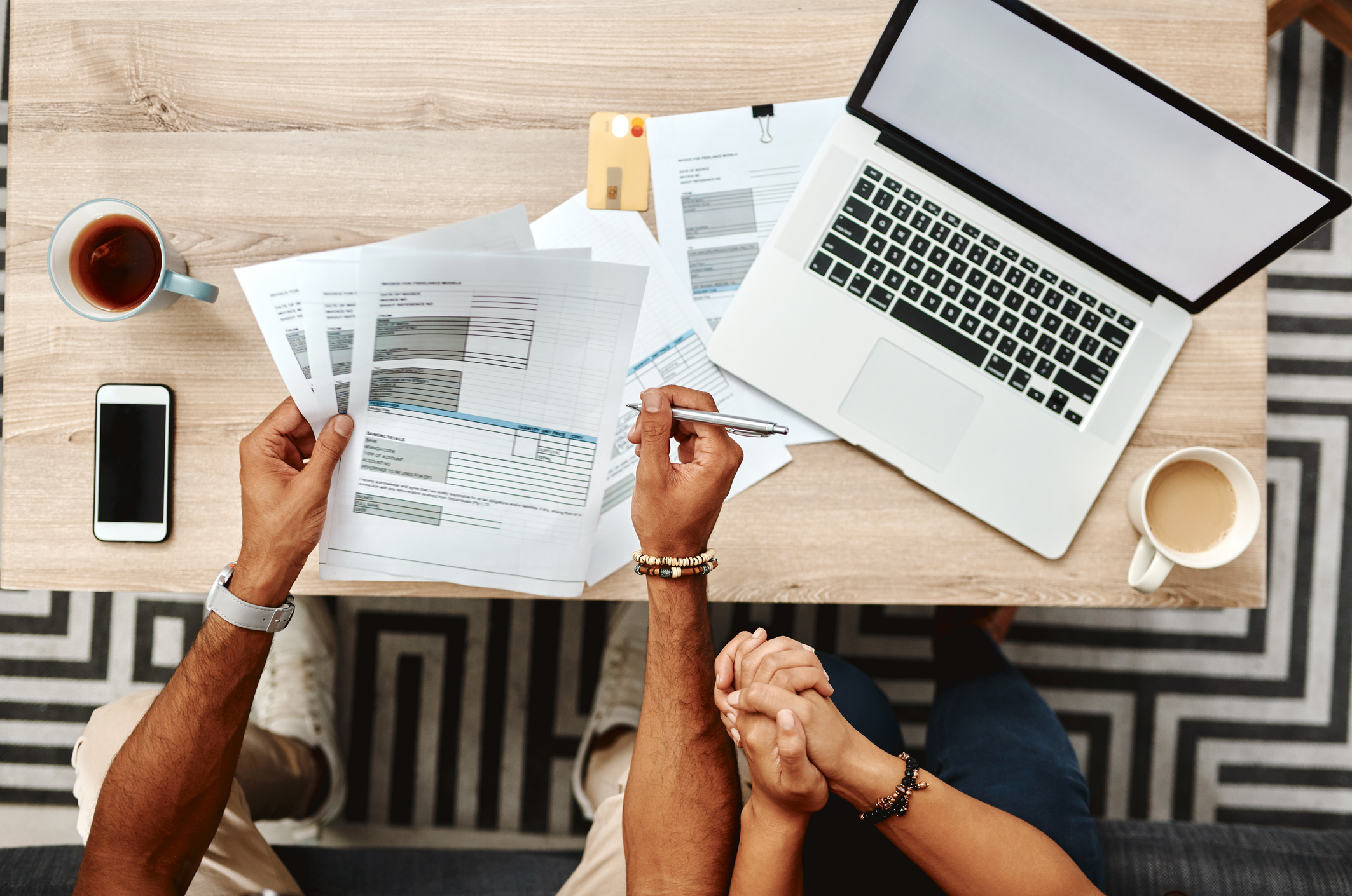 Cropped high angle shot of a couple going over their finances together at home