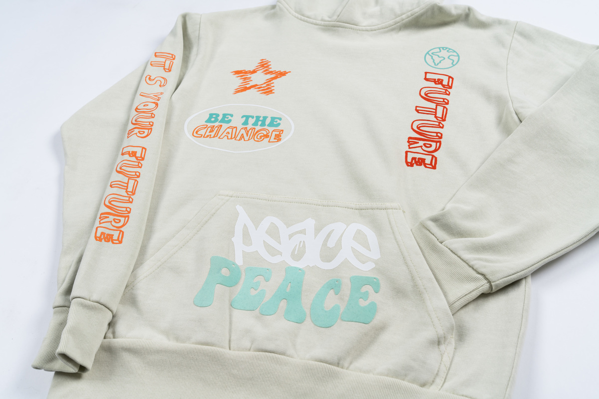 A white hoodie featuring several DTF transfers