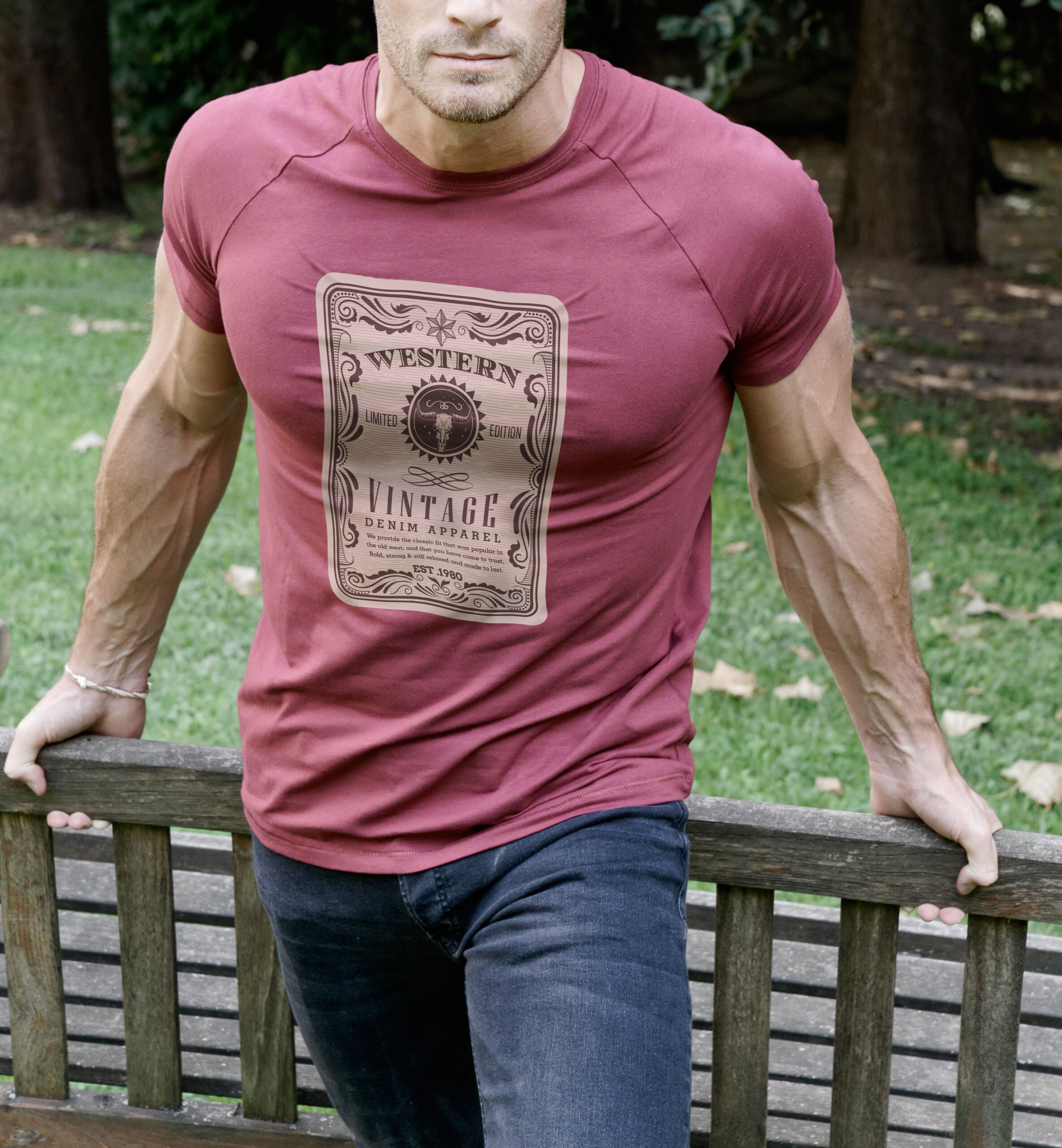 A man wearing a magenta T-shirt with a stretched out transfer design