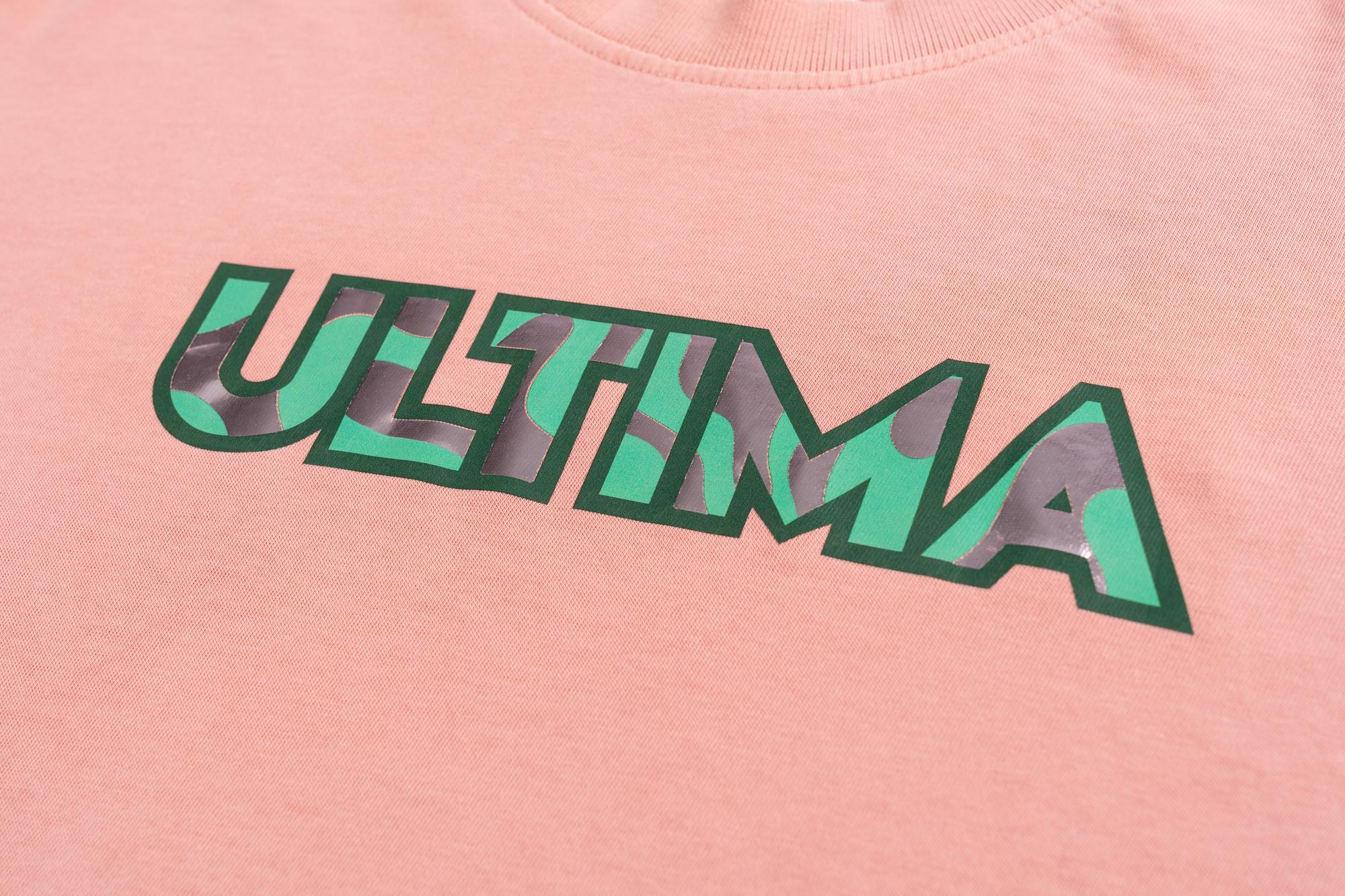 Ultima printed in green and pink design on a pink shirt