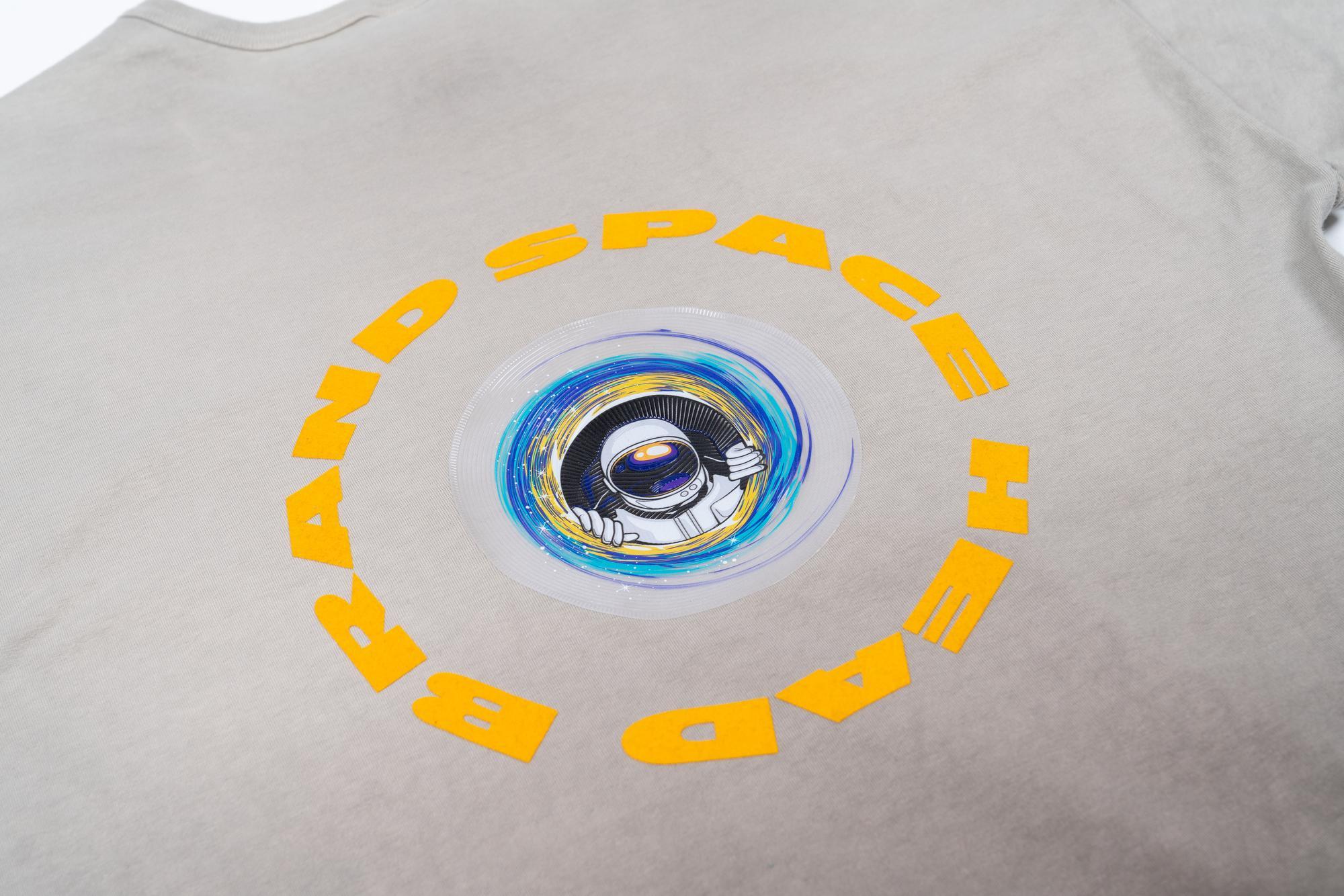 A white shirt with a dimensional yellow transfer print