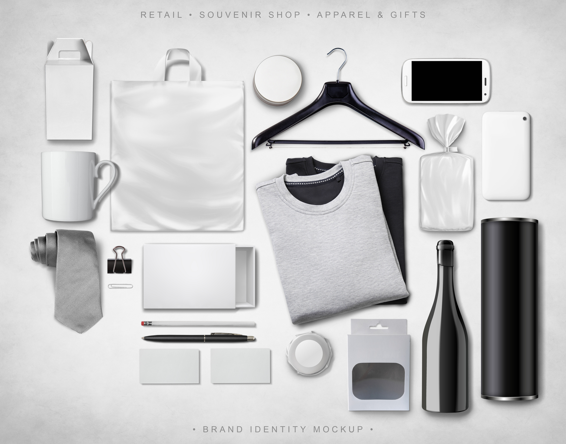 A black, white, and gray image of multiple promotional products laid out on a white background