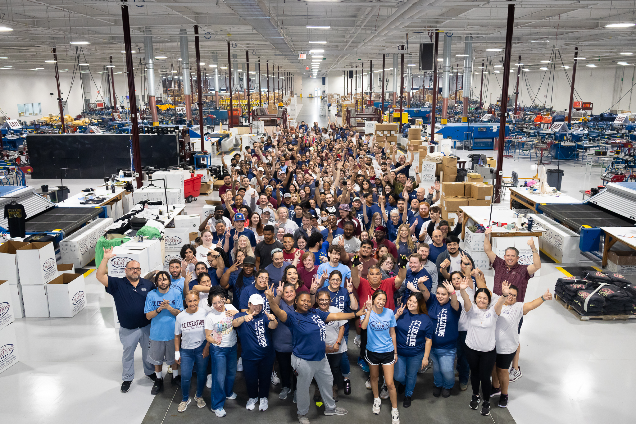 The team at C.C. Creations all standing in a group picture taken at an overhead angle