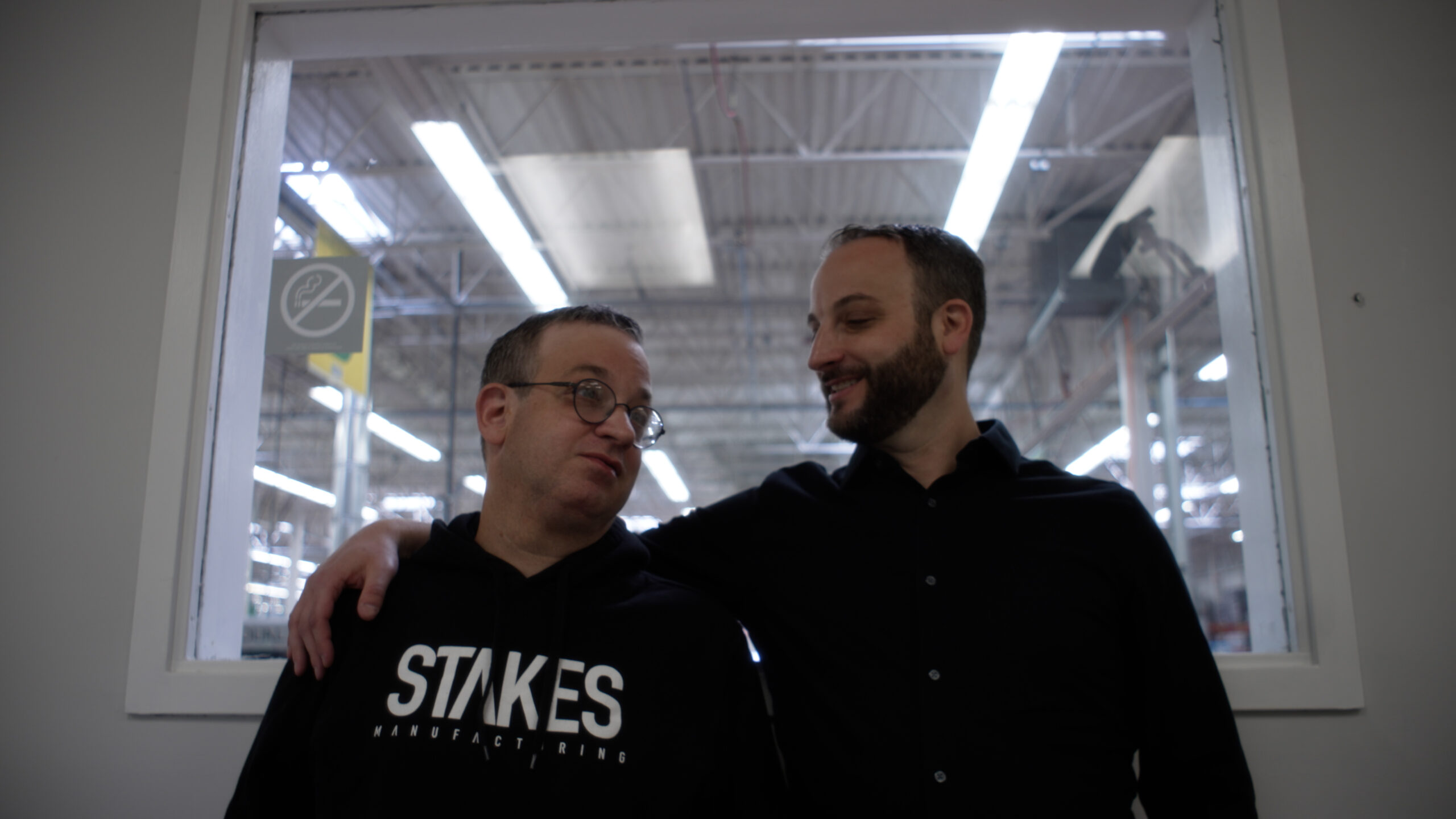 Left: Darren Seifert wearing a black Stakes hoodie; right: Jed Seifert wearing black shirt