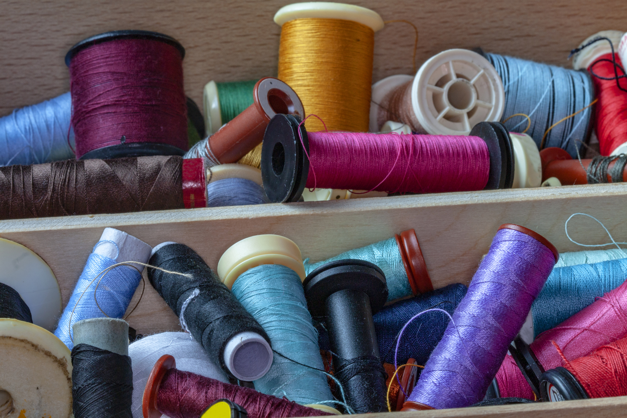 embroidery thread in a messy arraangement on shelves