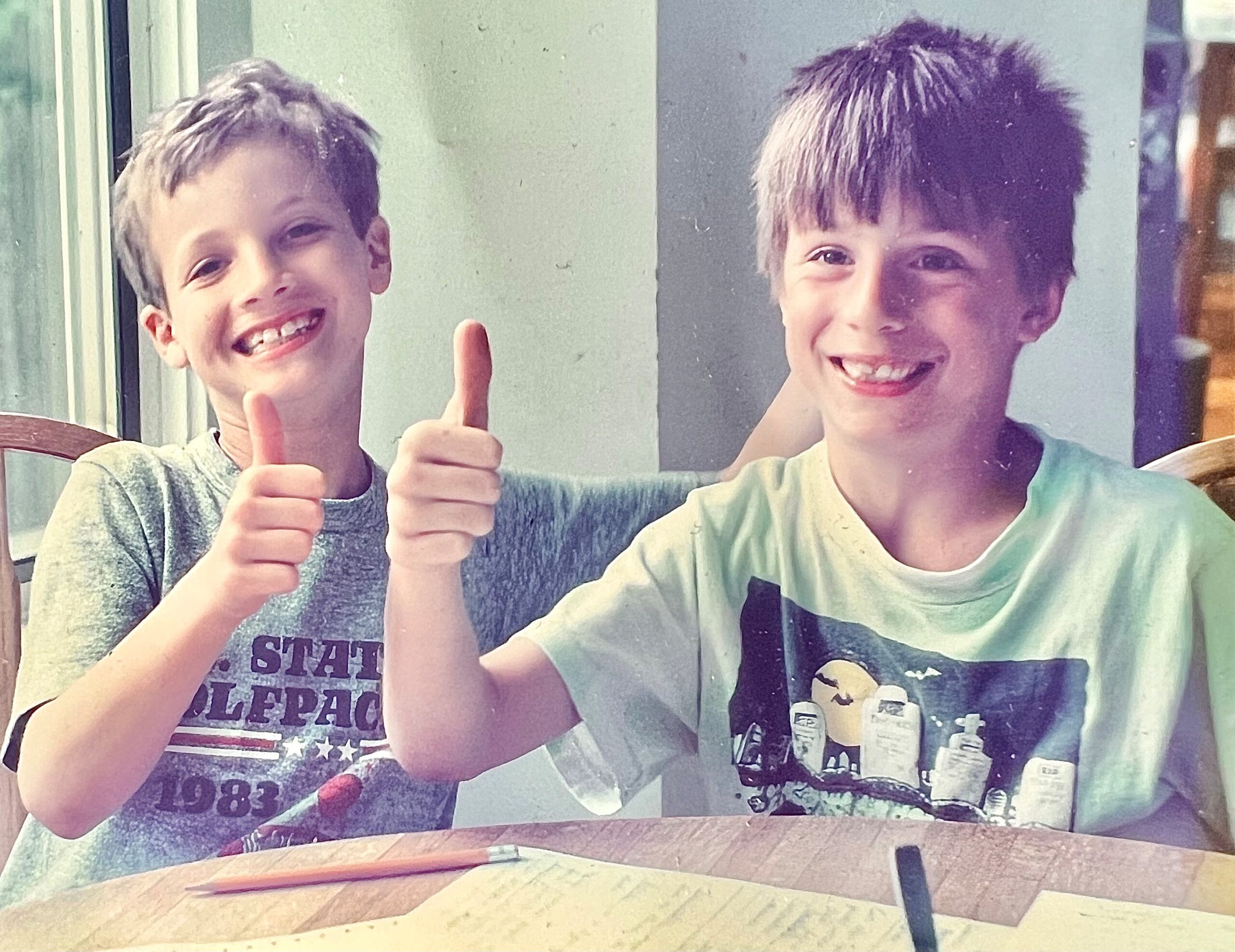 Left: Jed Seifert wearing a gray shirt, right: Vince Bartozzi wearing green shirt; both giving a thumbs up