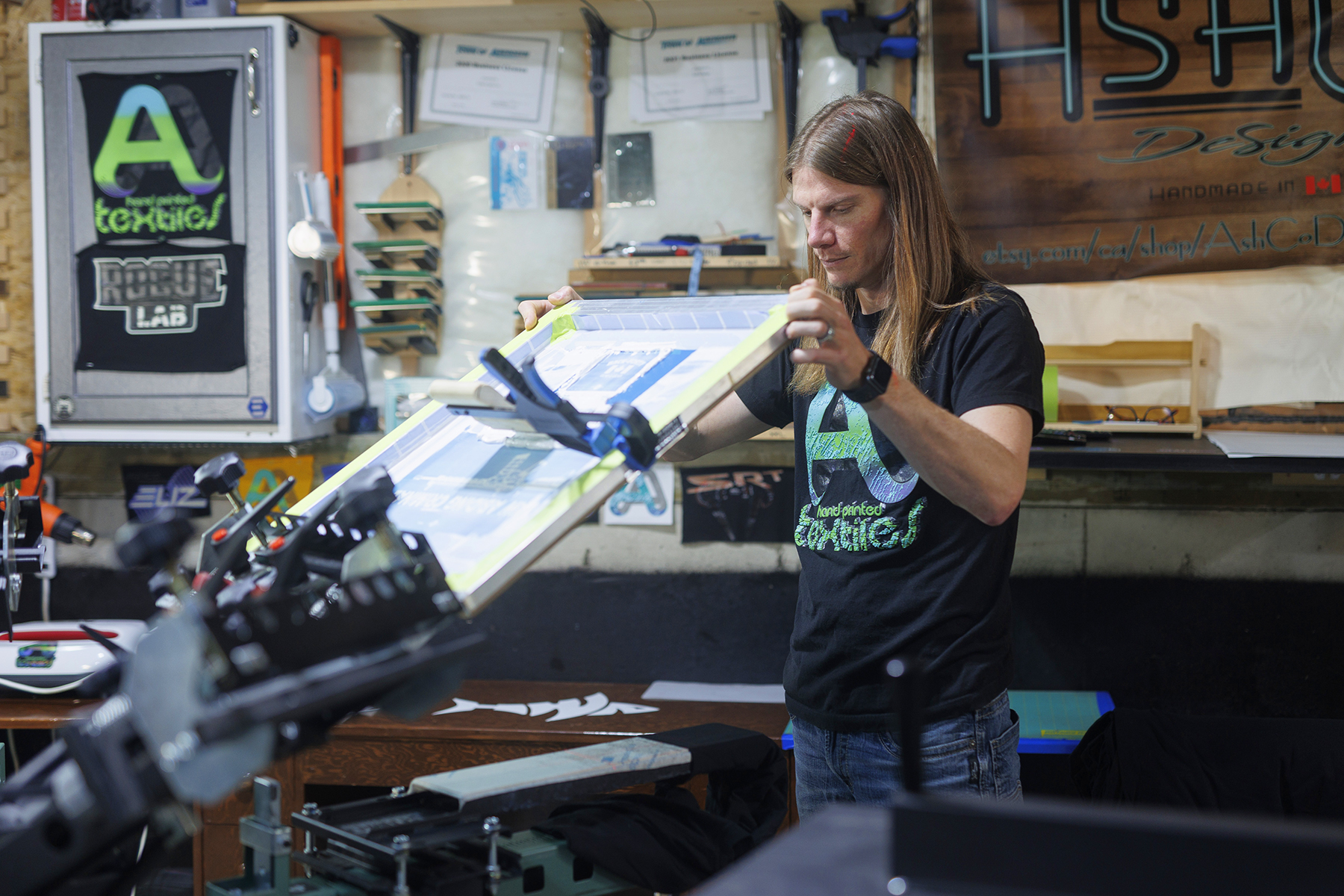 Chris Moulds, owner of AshCo Design, prints raised designs with his V-2000HD 6-color/ 6-station press.