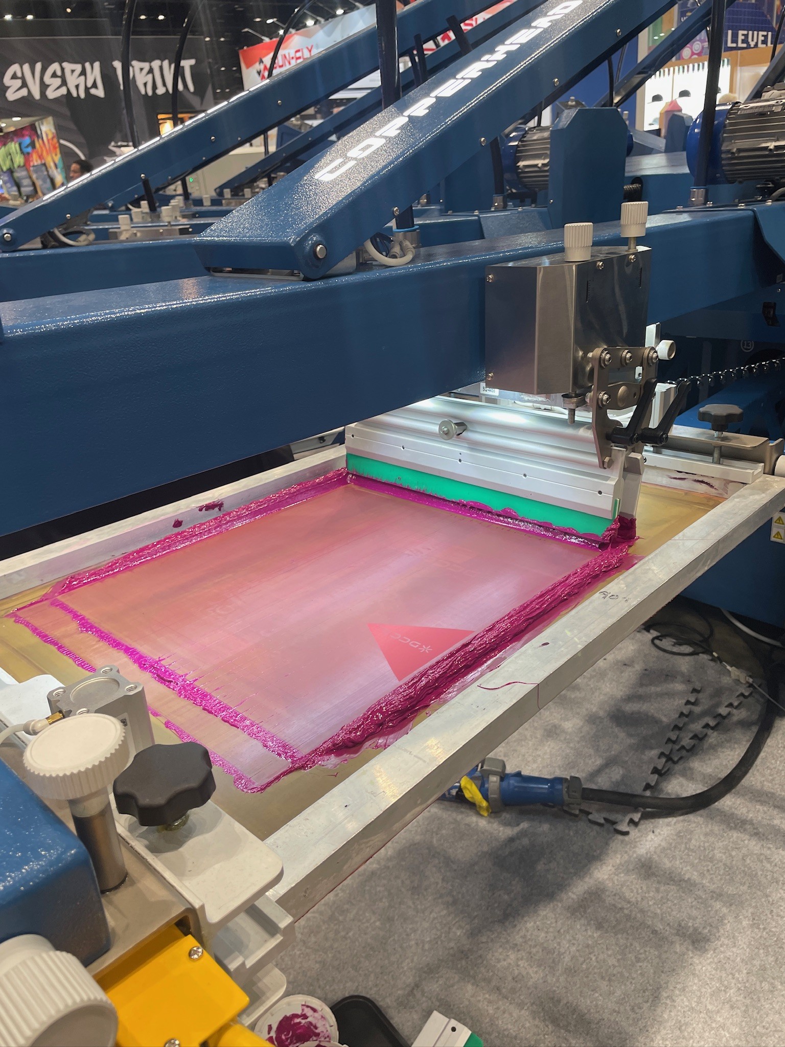 A close-up image of a screen printing press