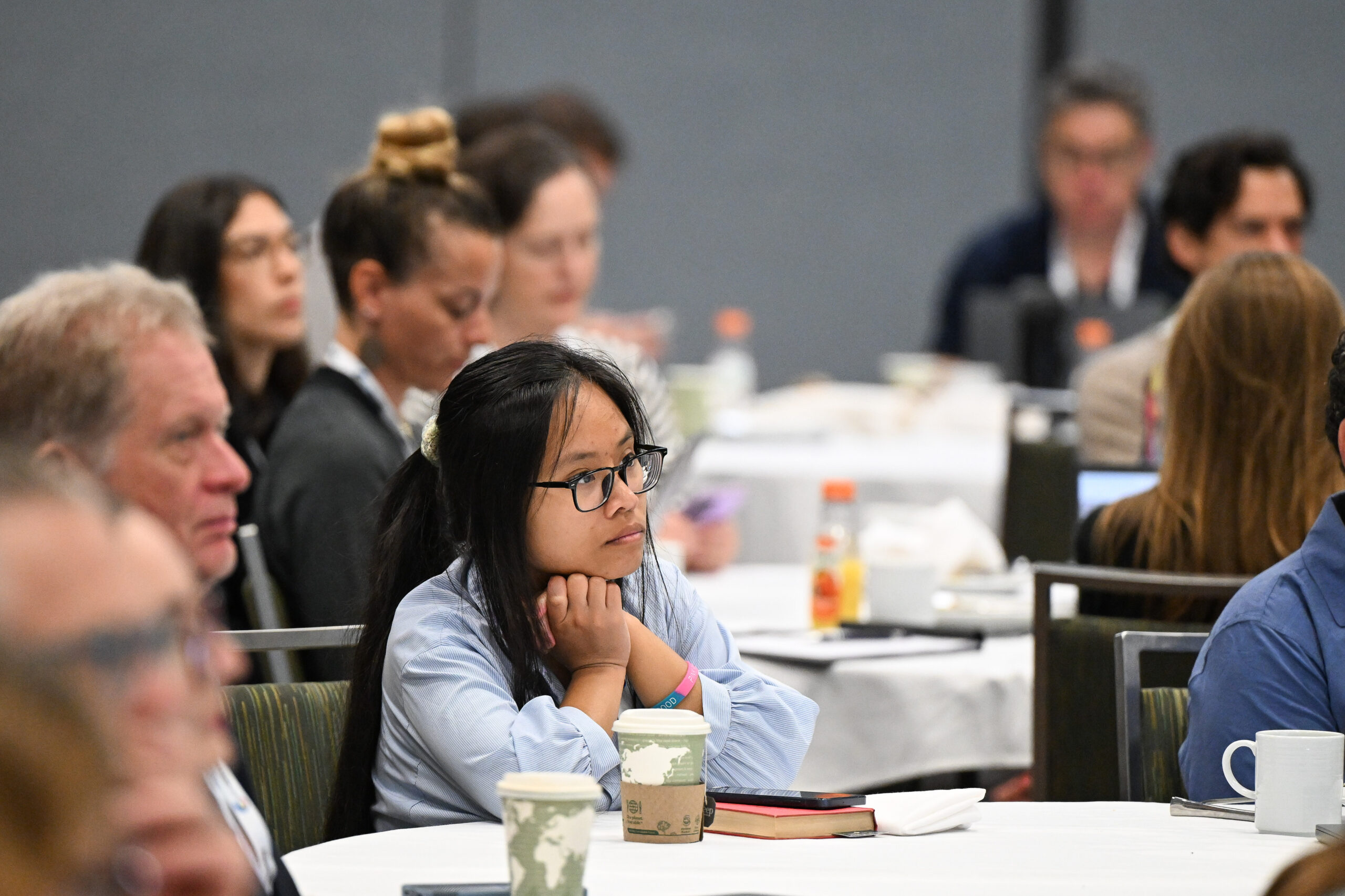 A group of people listen into presentations
