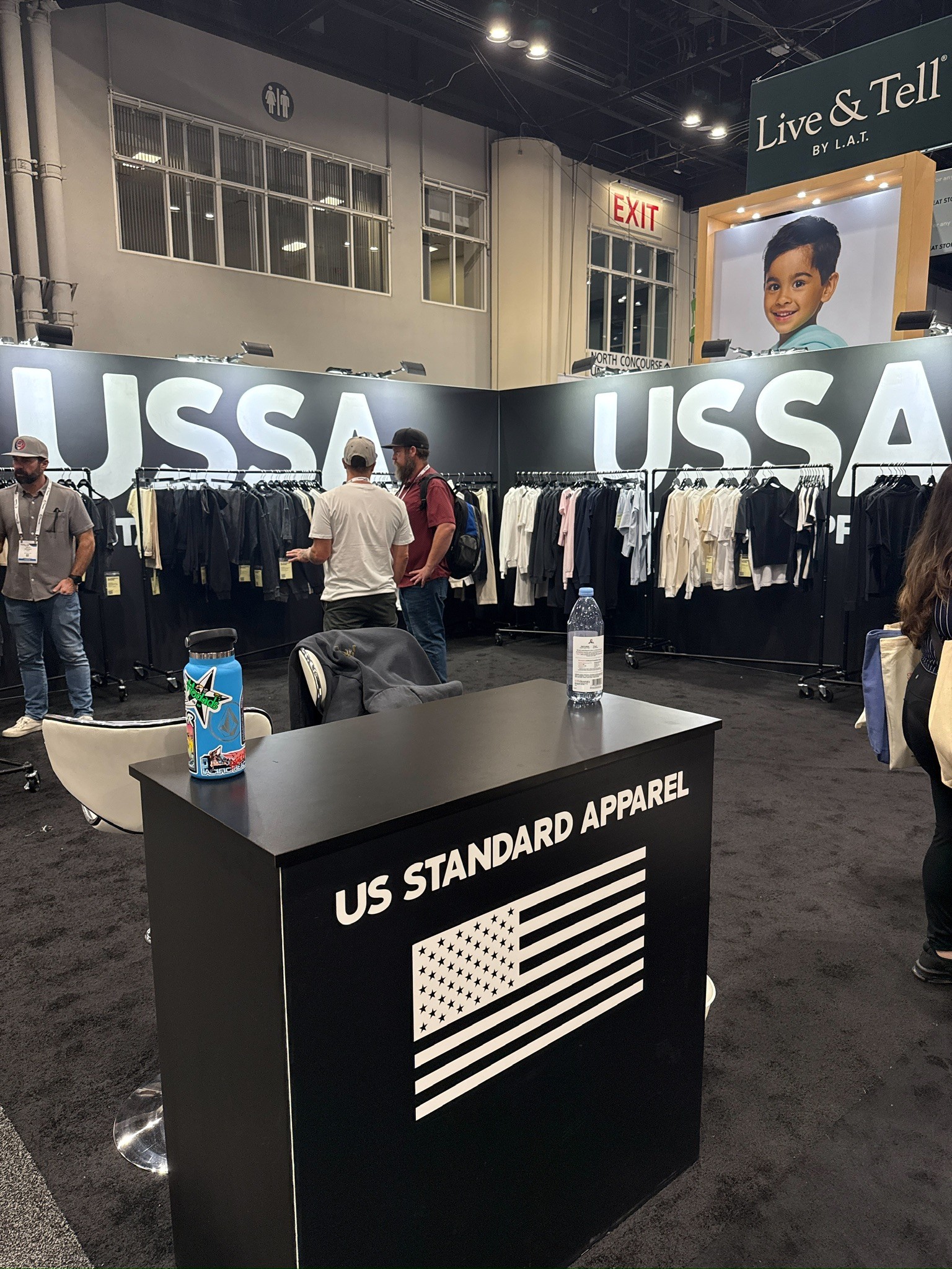 A wide angle image of USSA booth with desk in the middle