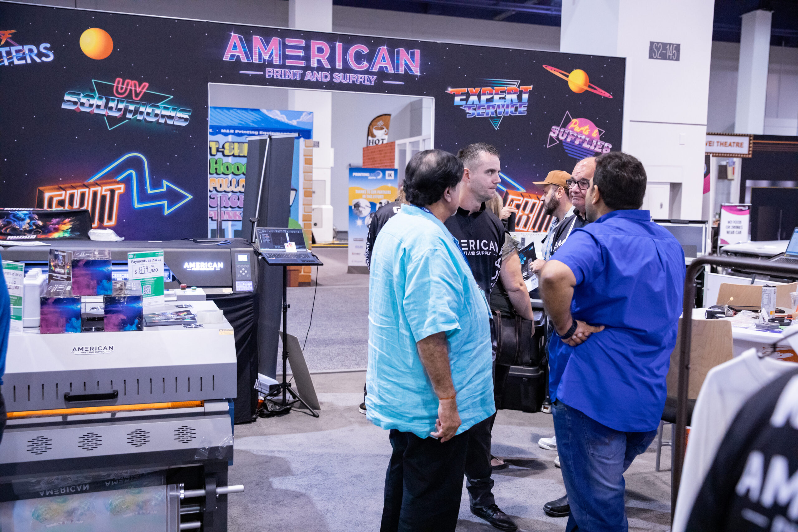 Rob Super standing with three other men at Apparel Zone