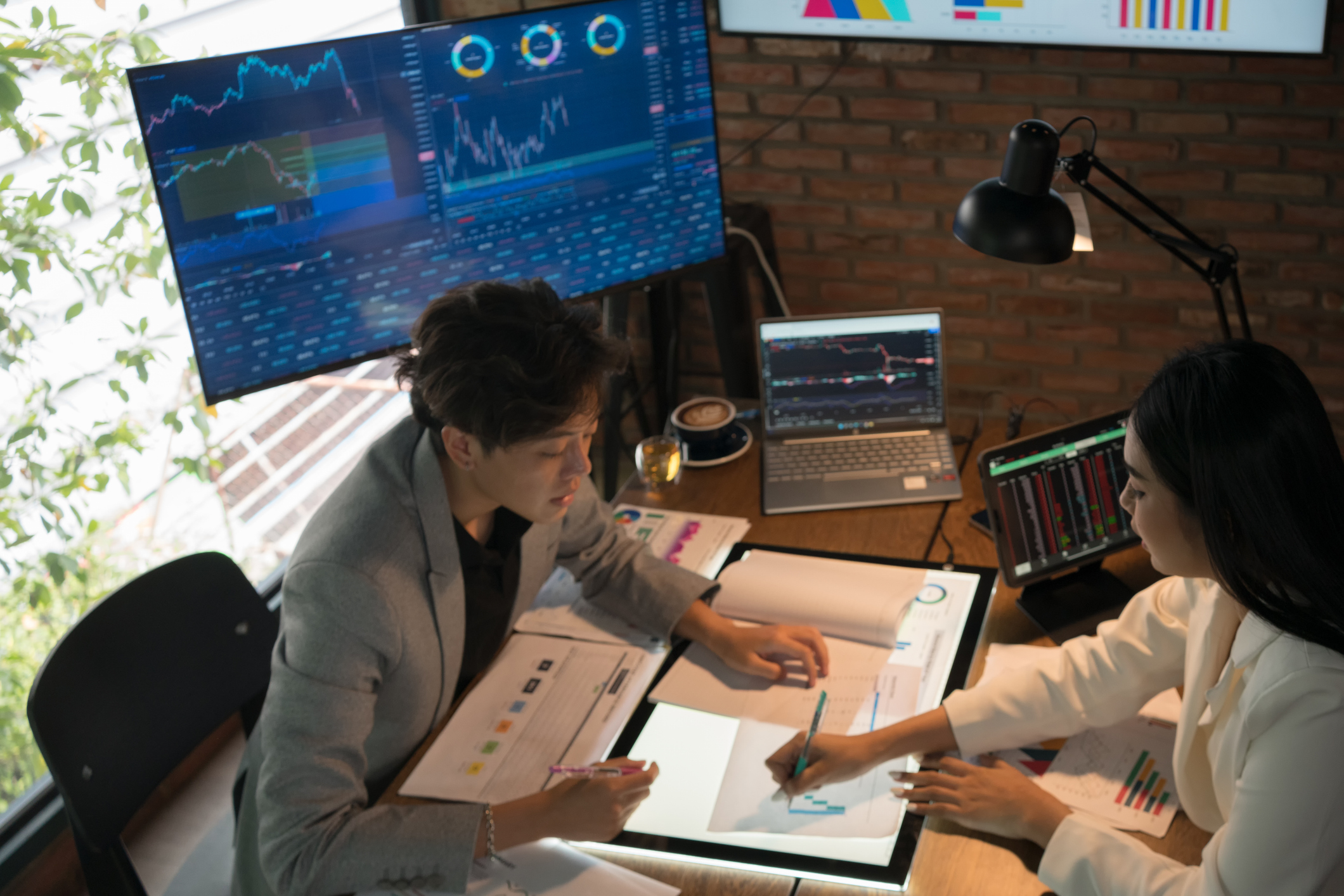 economic planning and forecasting between two people with charts and graphs