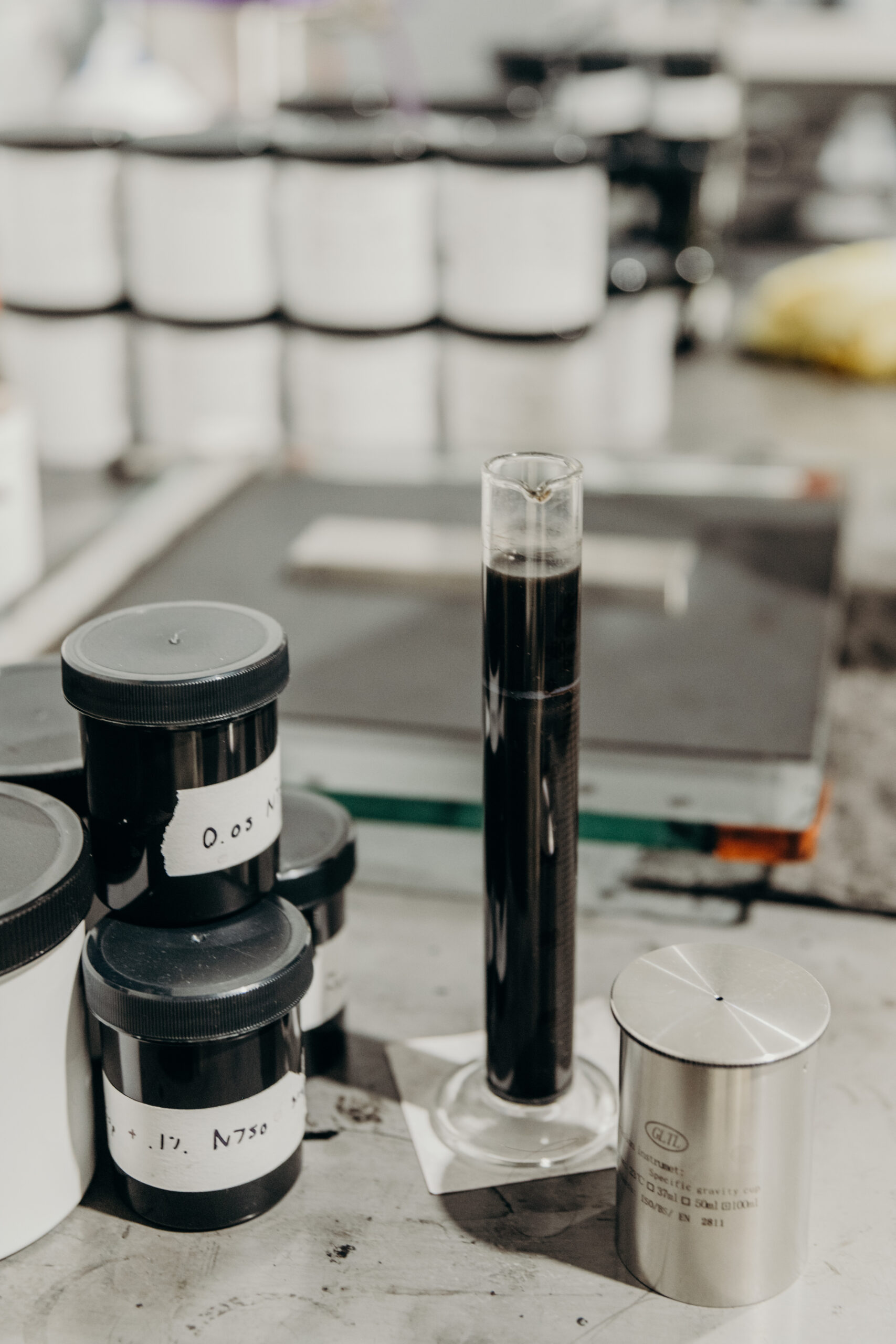 containers filled with black ink samples