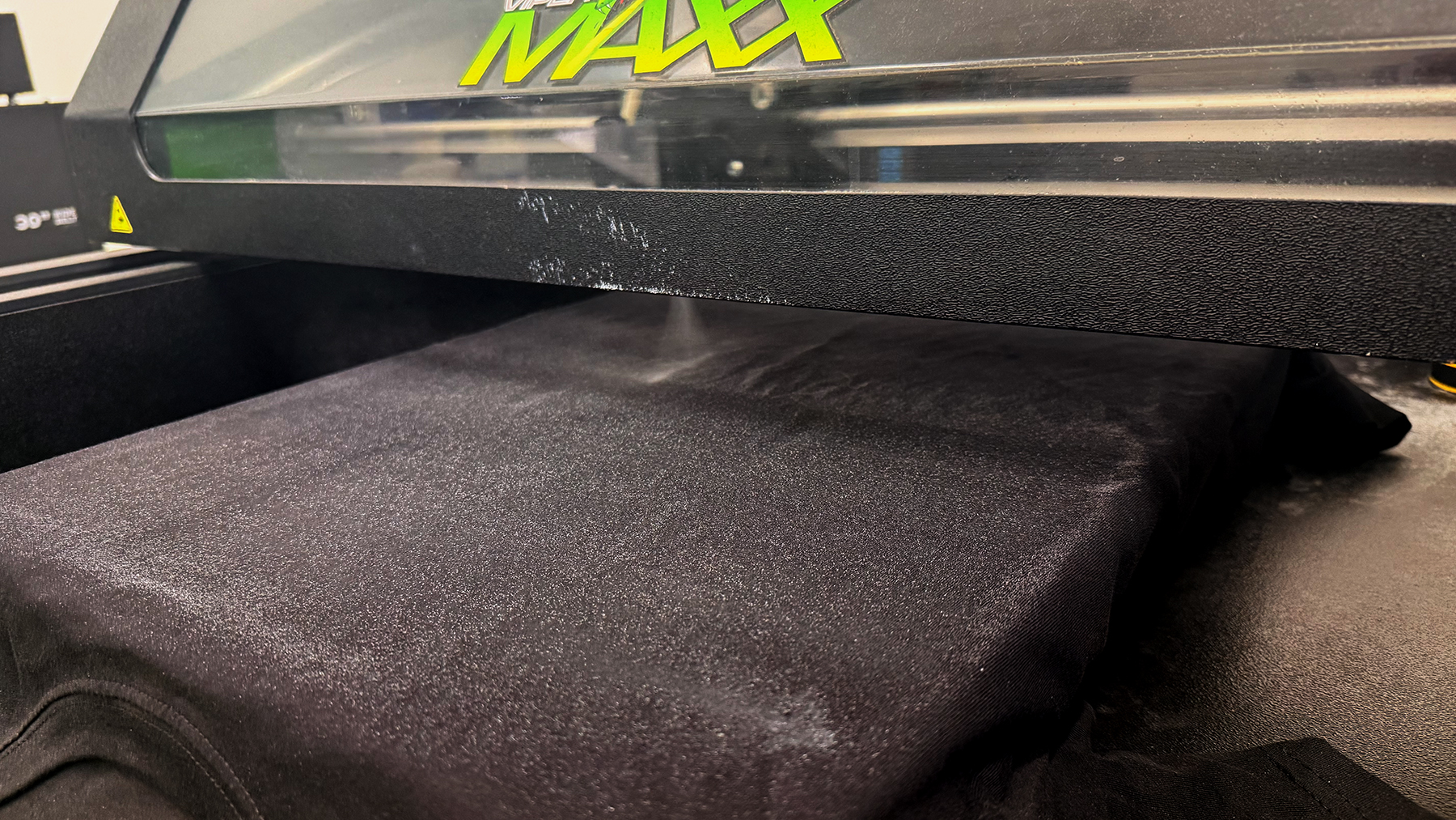 a black shirt getting pretreat applied