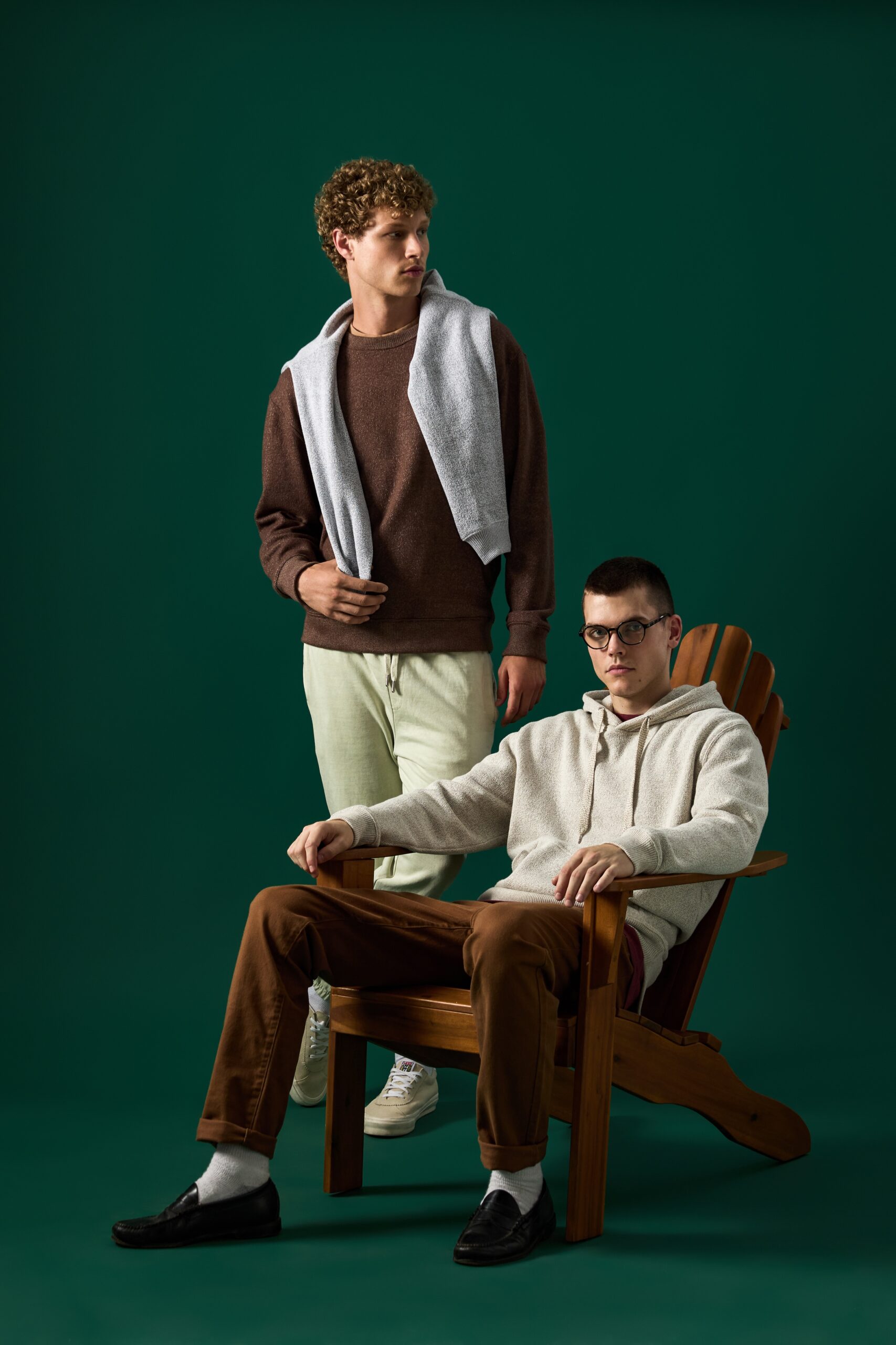 two models wearing sweaters in burgundy and cream