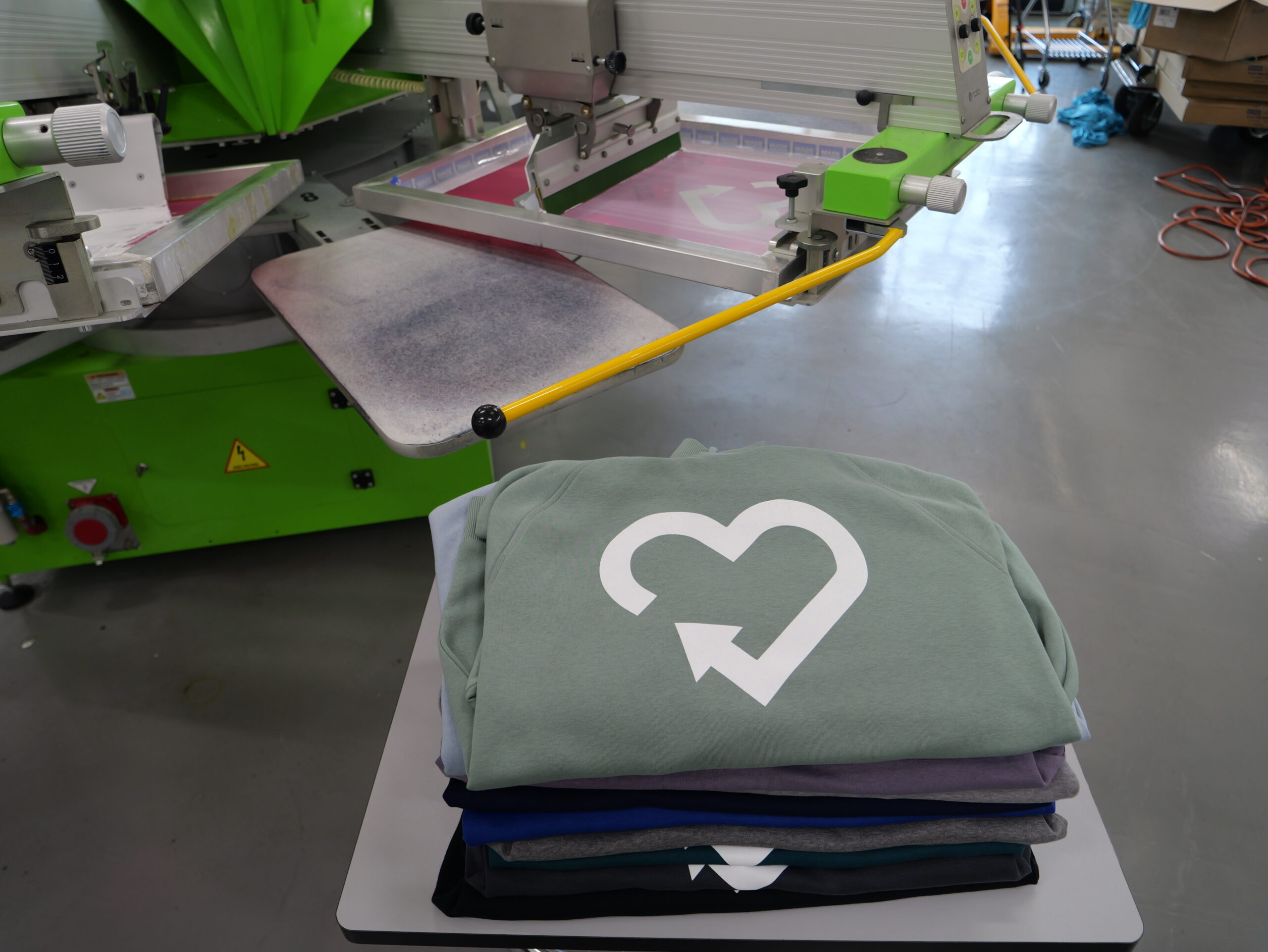 white heart screen-printed on green T-shirt