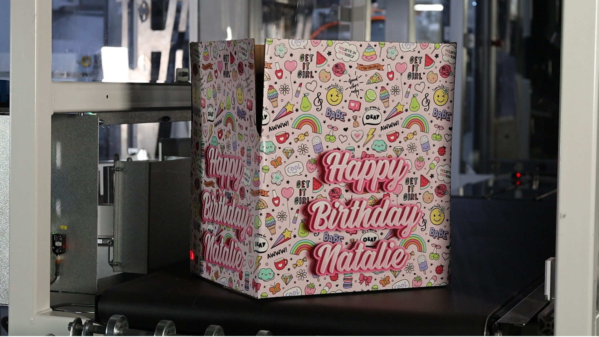 a box printed with pink decoration that says happy birthday natalie