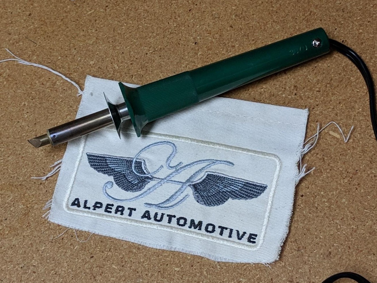 hot knife laying on embroidered textile
