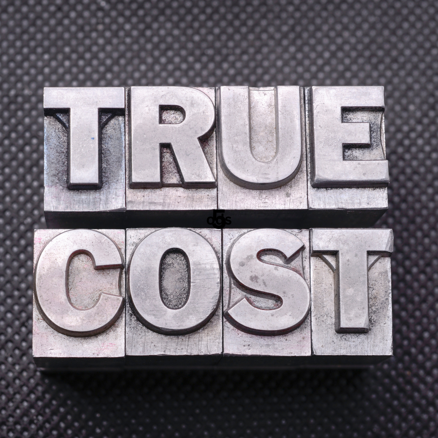 true cost depicted as metal stamp