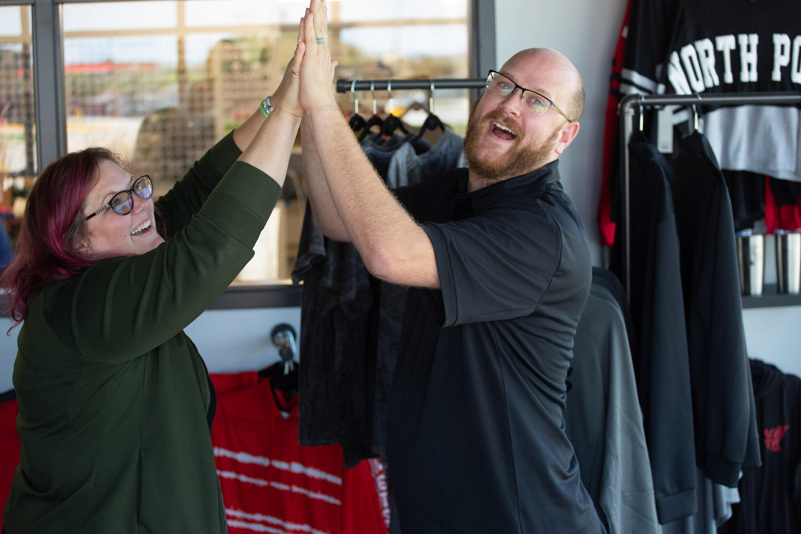 woman and man standing with their hands together