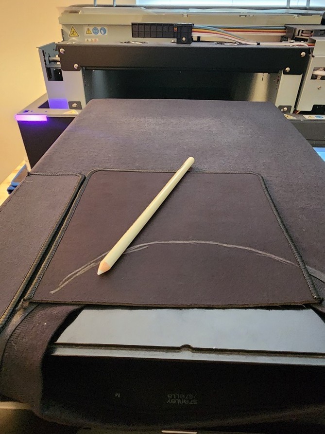 pencil on black shirt loaded onto platen