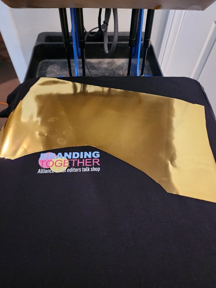 piece of gold foil laying on black shirt
