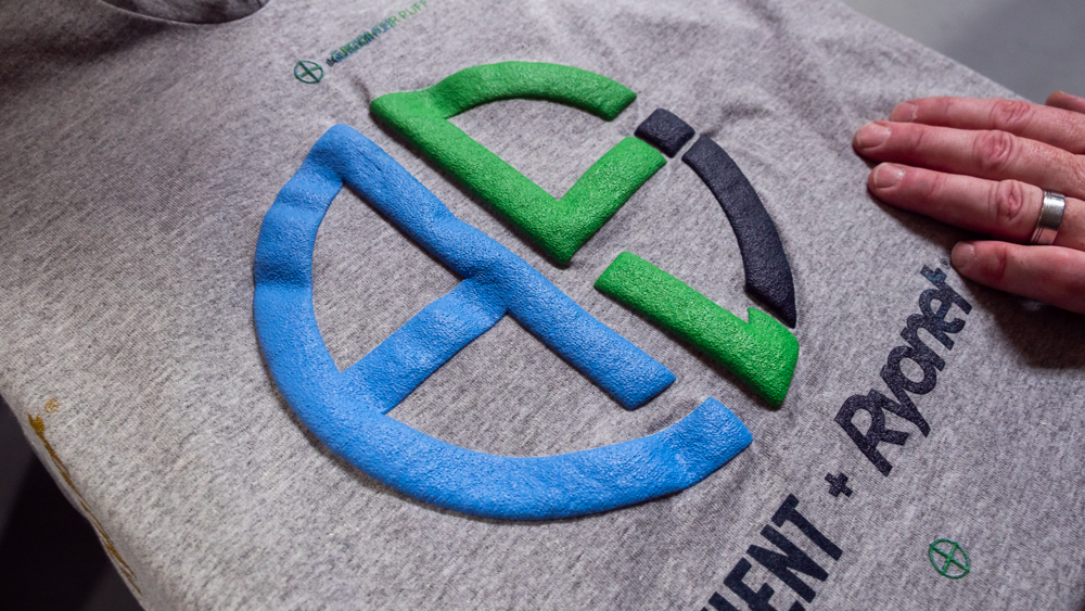 gray tshirt with blue, green, and black puff ink print