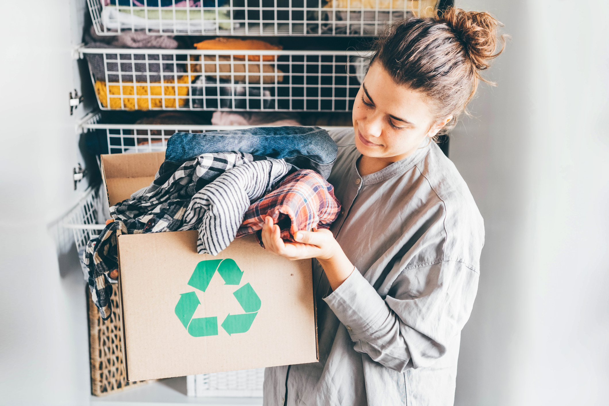 woman holding box of clothing