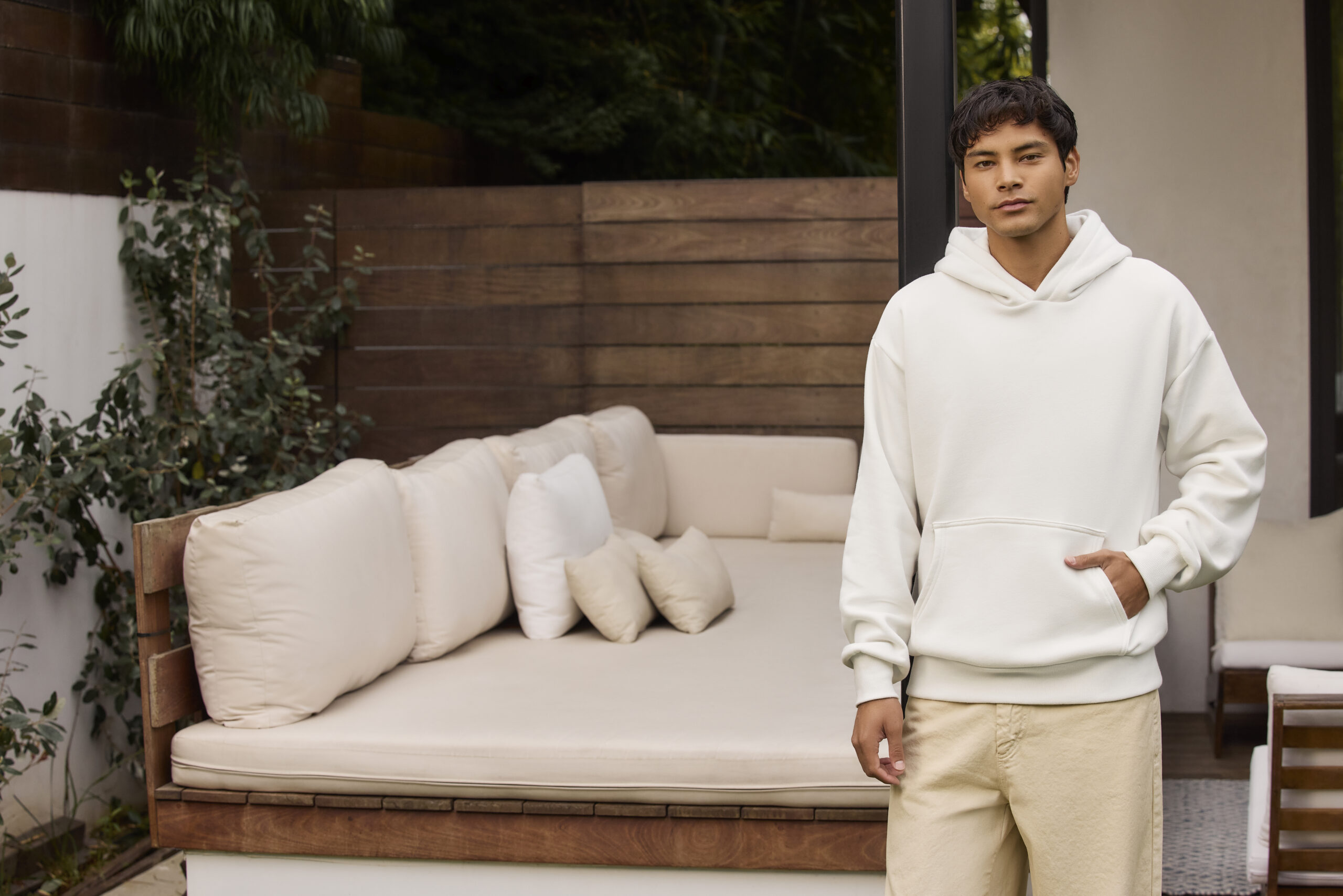 man wearing white hoodie on outdoor patio