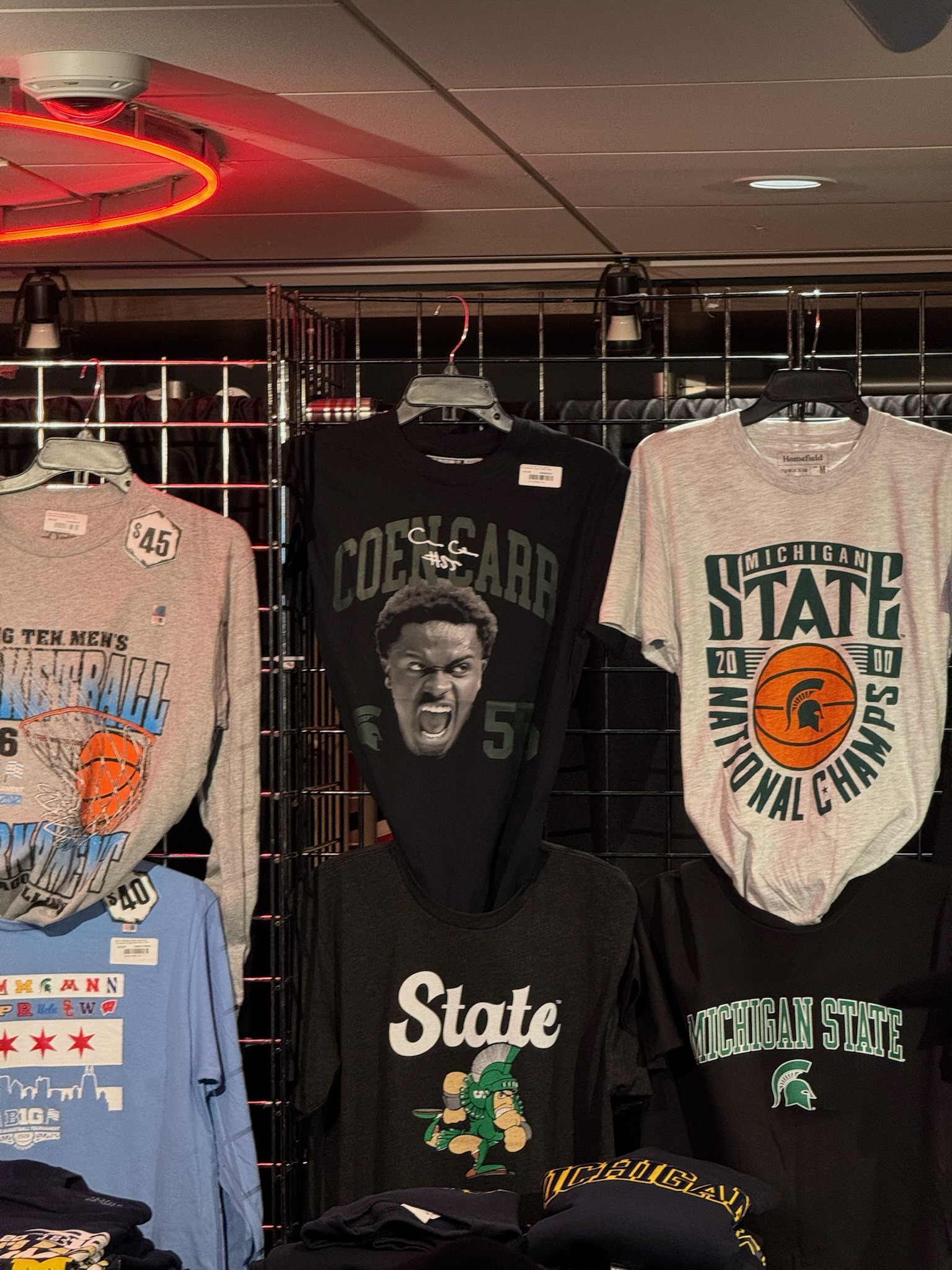 wall of black, white, and blue shirts