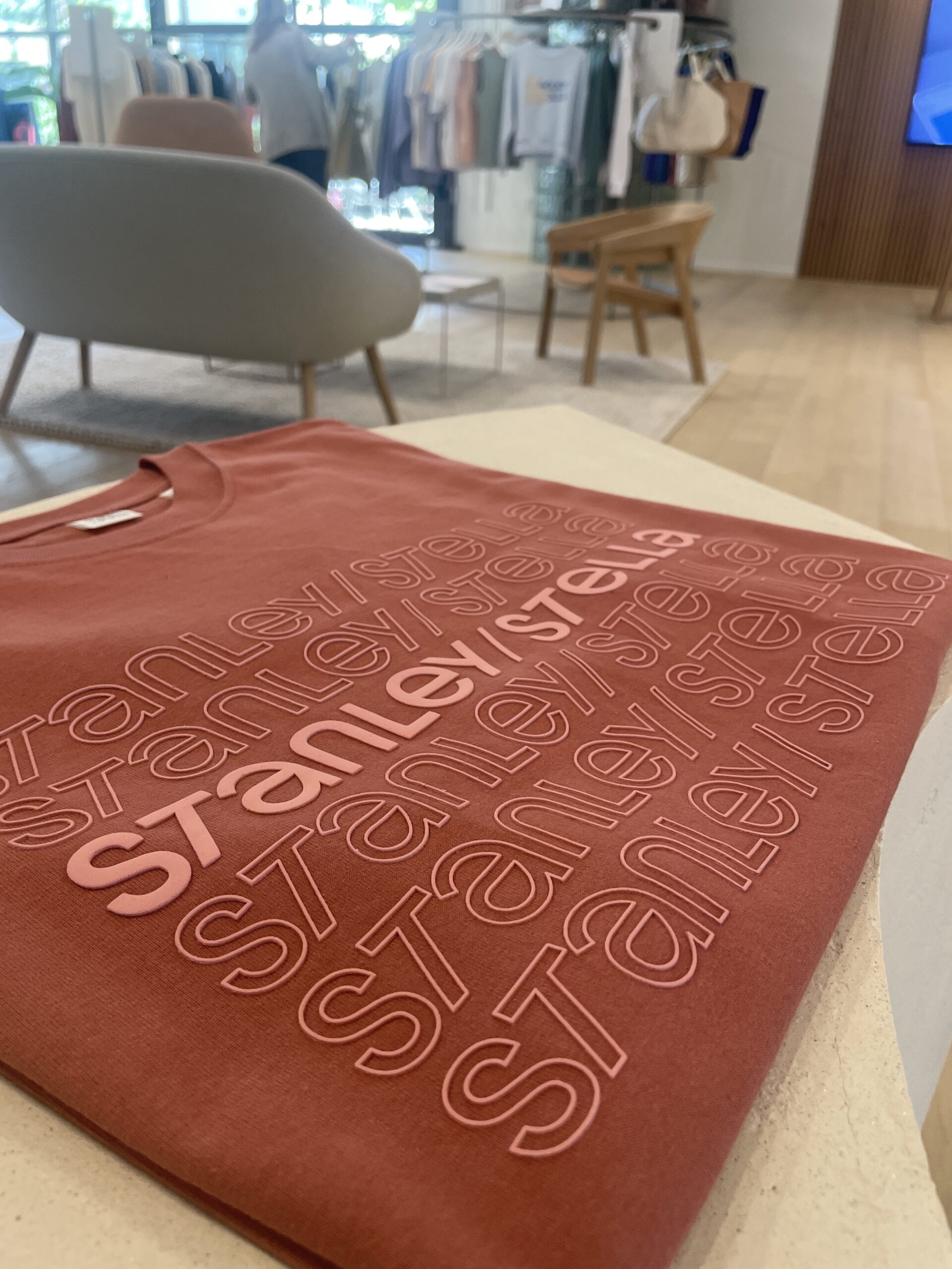 stanley stella printed on rust colored shirt