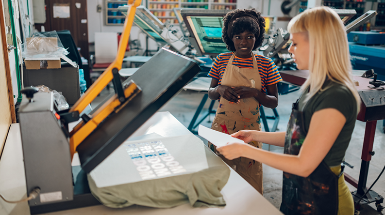 two women using heat press