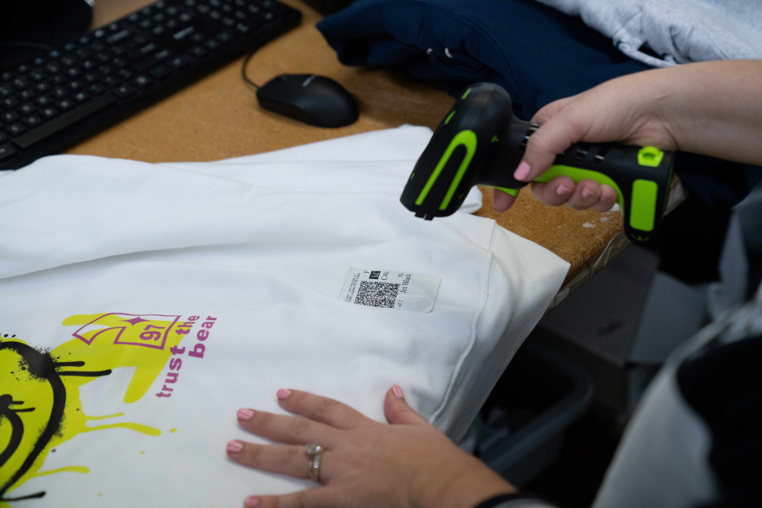 person scanning QR code on tshirt