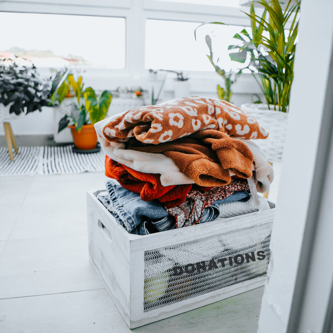 donations box full of clothes for charity at the entrance of house